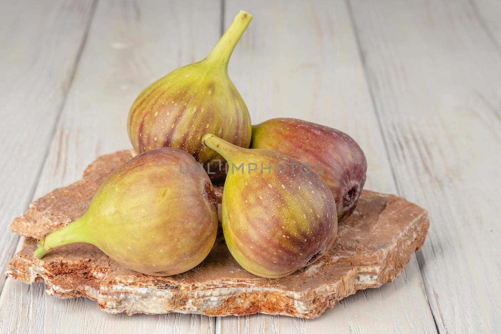 Fresh, light, healthy figs on white wooden background by Fischeron