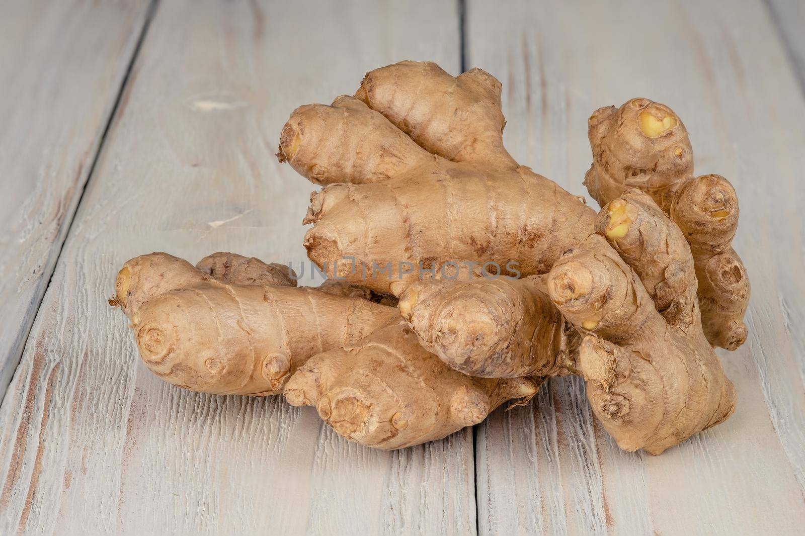 Fresh, light, healthy ginger on white wooden background by Fischeron