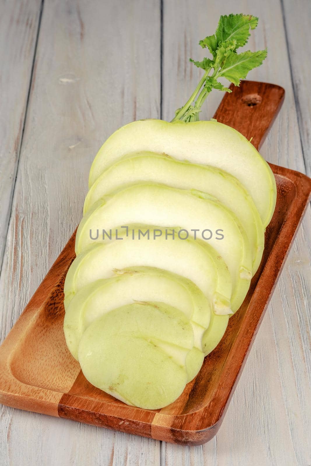 Fresh healthy kohlrabi sliced on wooden background.