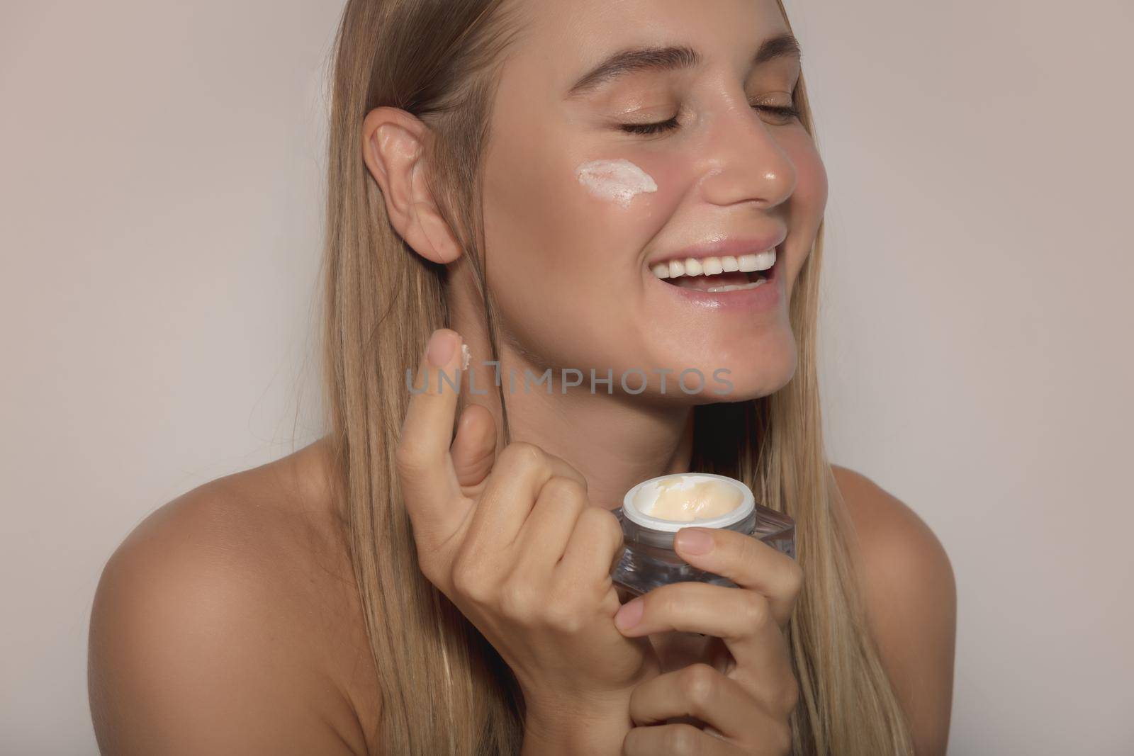 Pretty Woman Applying Cream by Anna_Omelchenko