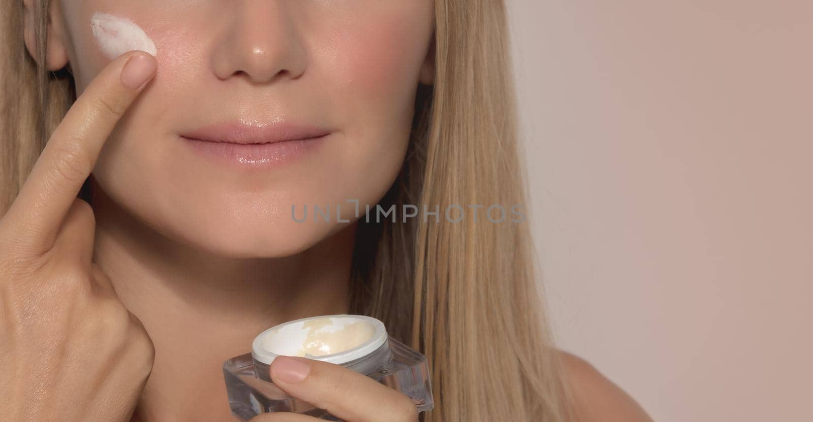 Beautiful Girl Applying Facial Cream by Anna_Omelchenko