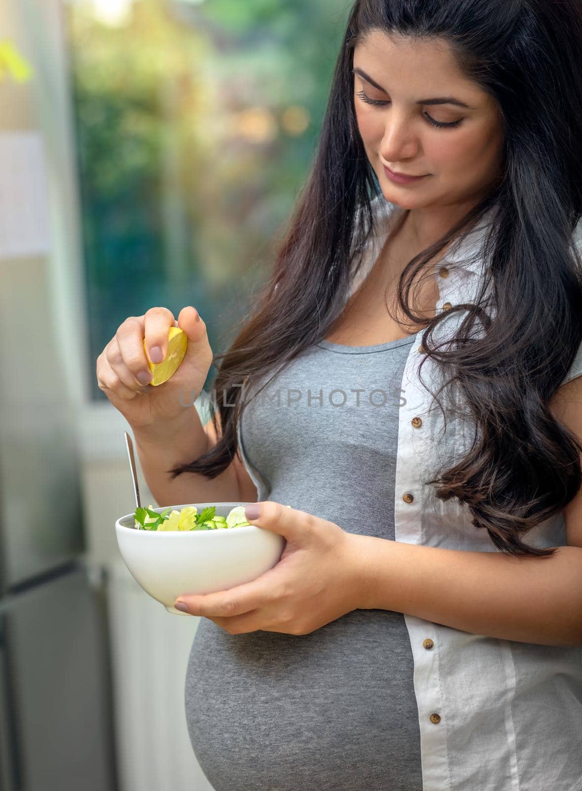 Pregnant woman eating a salad by Anna_Omelchenko