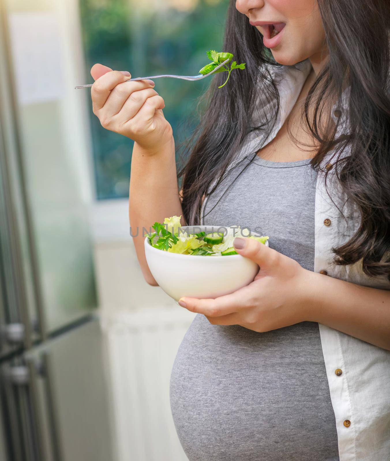 Pregnant Woman Eating a Salad by Anna_Omelchenko