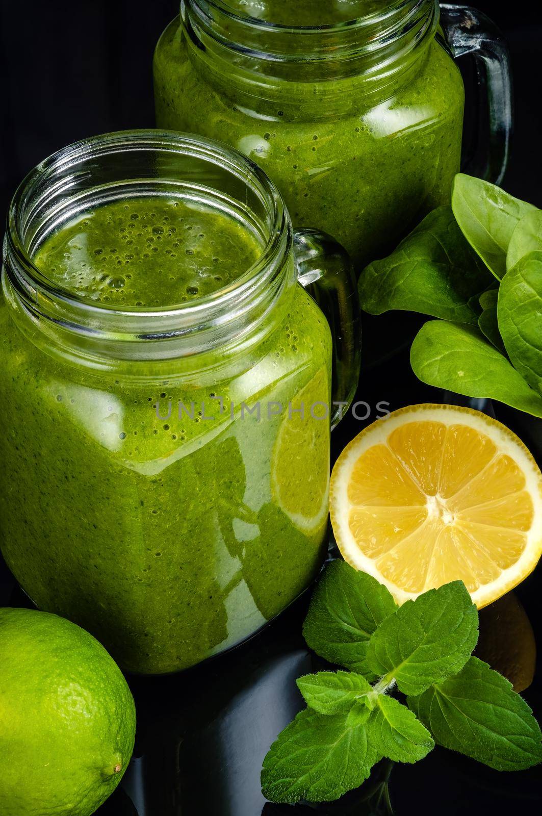 Healthy green smoothie with spinach in glass jars. by Fischeron