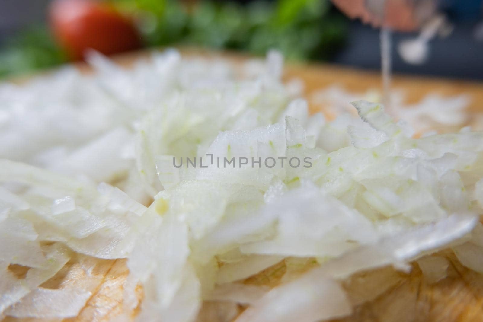 Close-up of chopped onions on a cutting board by Kanelbulle