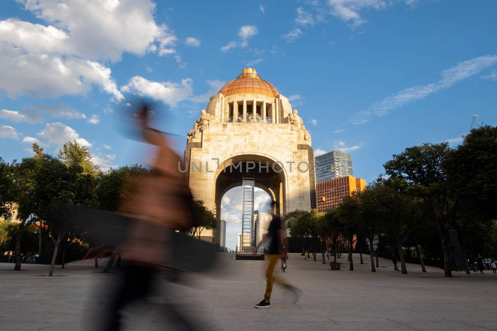 Mexico City, Mexico - January 13, 2021: Time-lapse of Monument to the Revolution with beautiful sky as background. Majestic triumphal arch in Mexico City with people passing by. Mexican landmarks