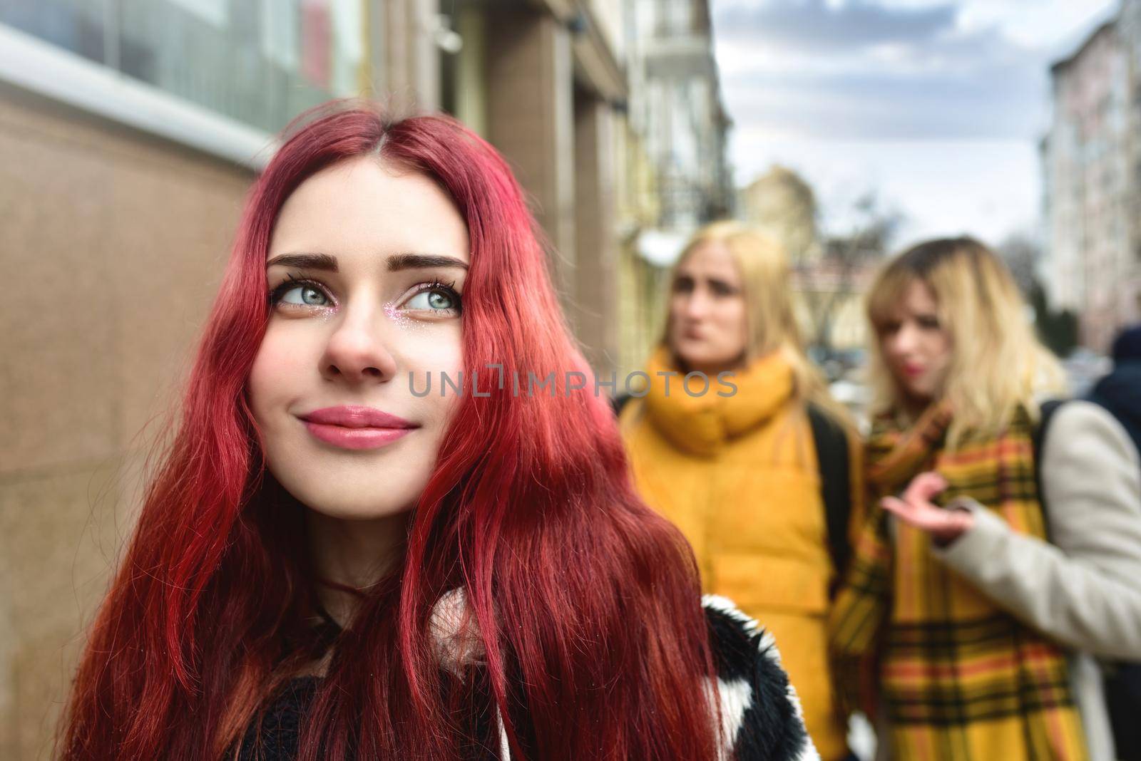 Self-confident teenage girl ignores jealous people who spread gossip behind her back. stop bullying. social problems by Nickstock