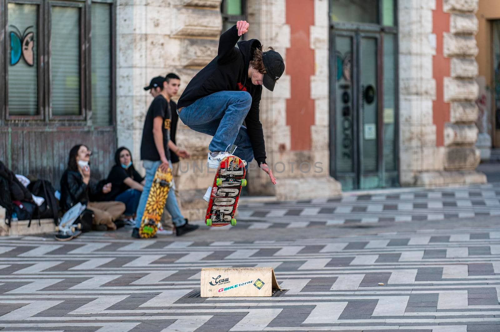 terni,italy march 16 2021:boys doing skateboard stunts in the city