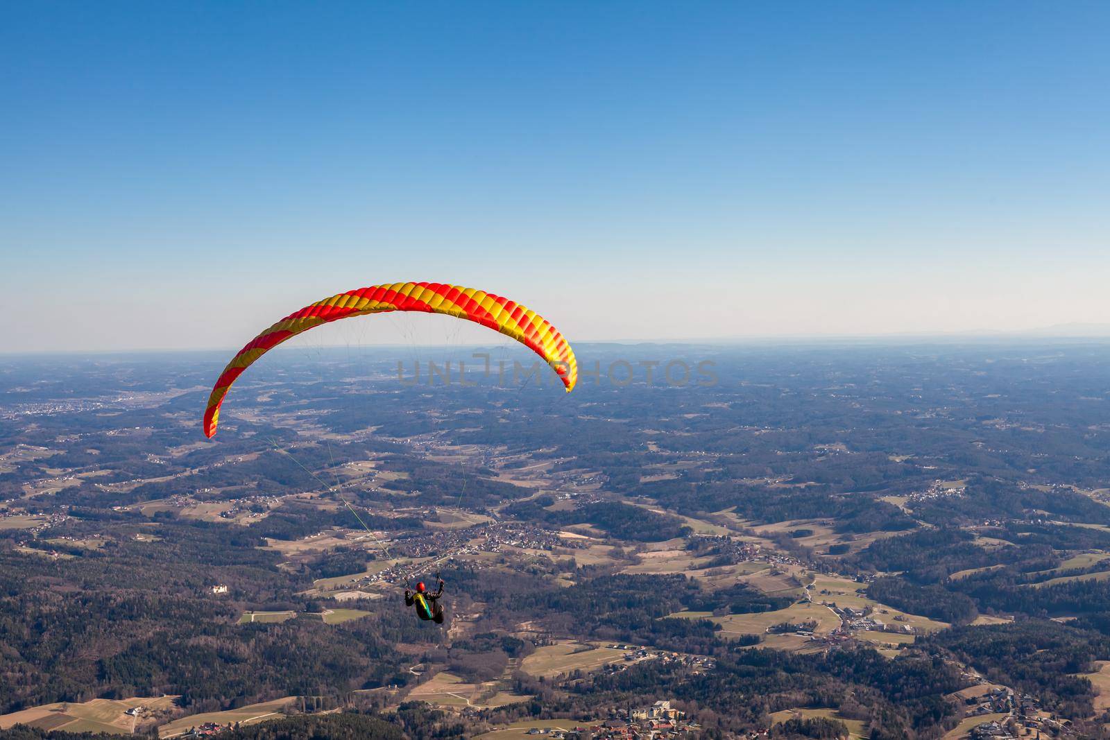 sports paragliding on a parachute over the countryside by Edophoto