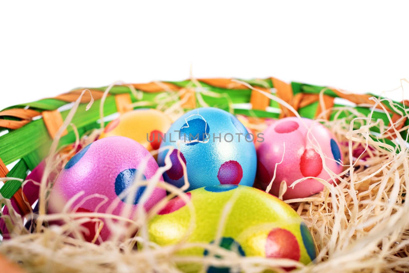 Colourful Easter eggs with polka dots in a basket by Mendelex