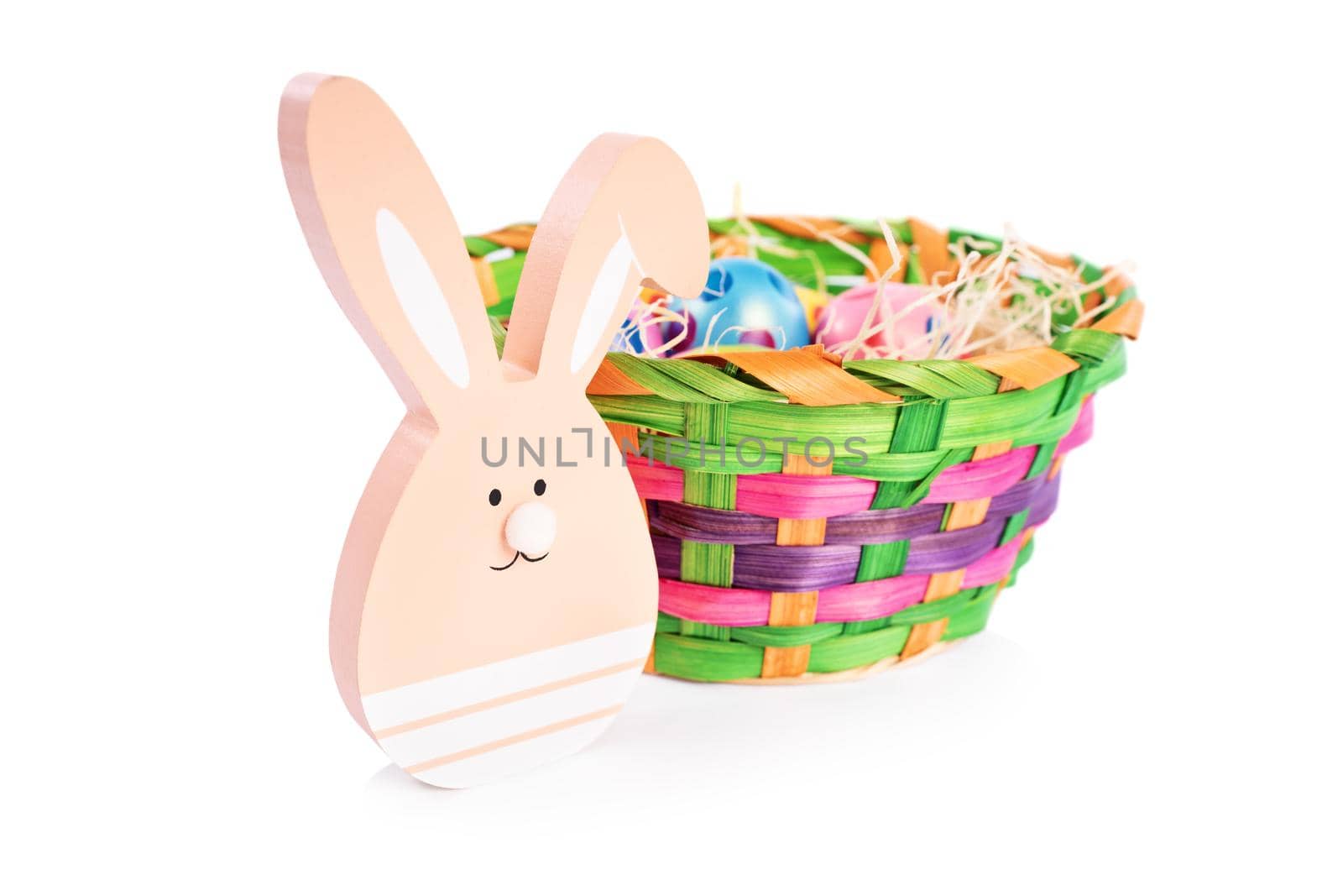 Easter bunny and a basket filled with colourful eggs by Mendelex