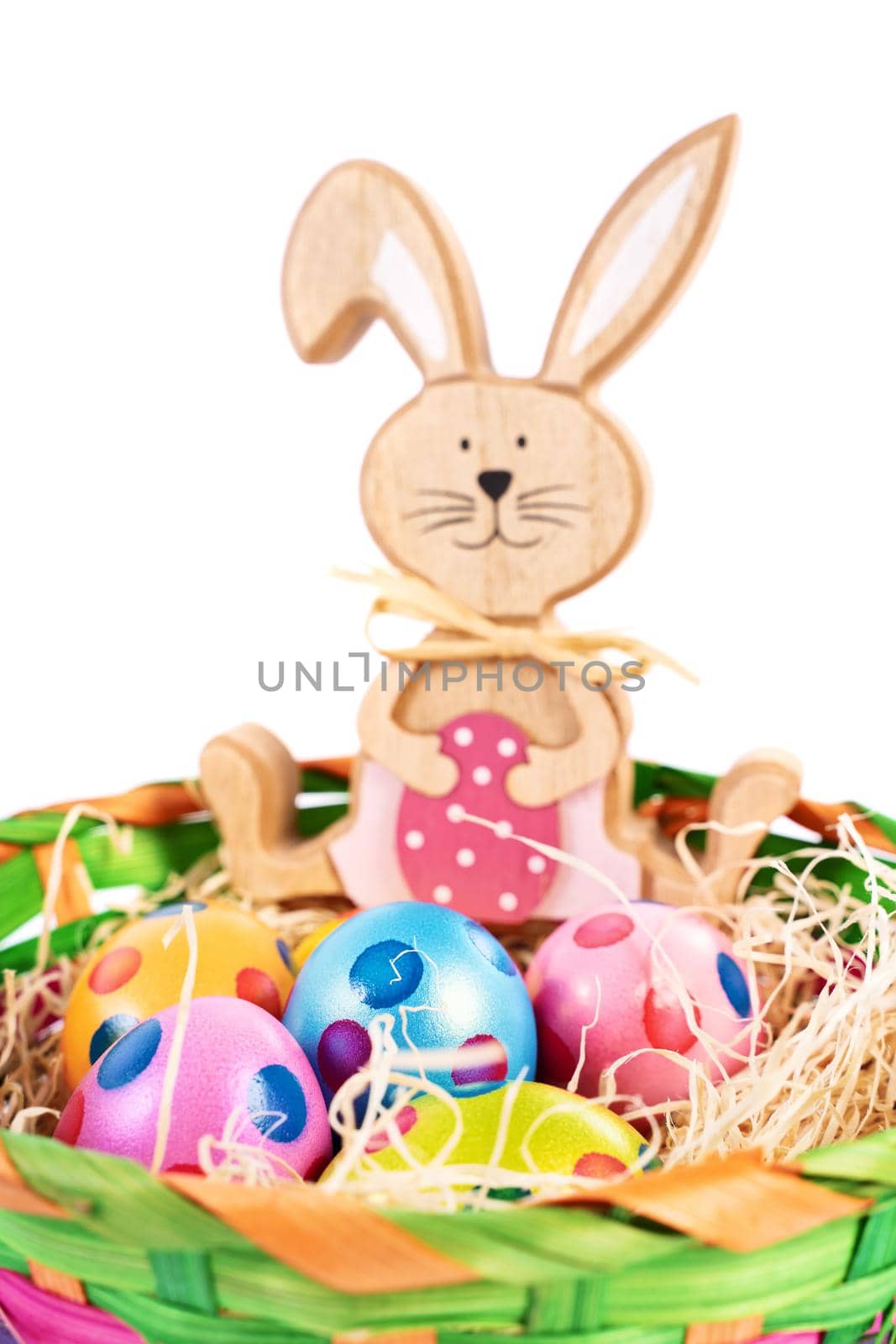 Easter bunny with colourful eggs with polka dots in a basket by Mendelex