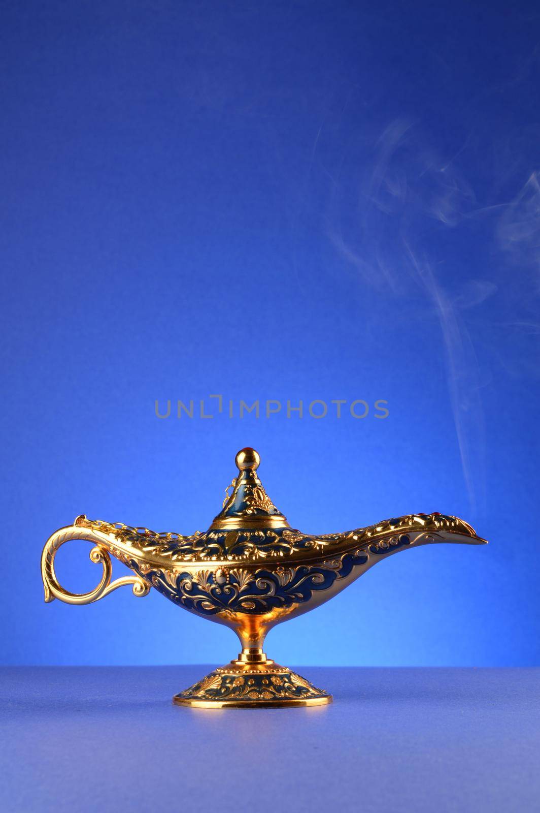 A magical lamp with a smoke trail over a blue gradient background.