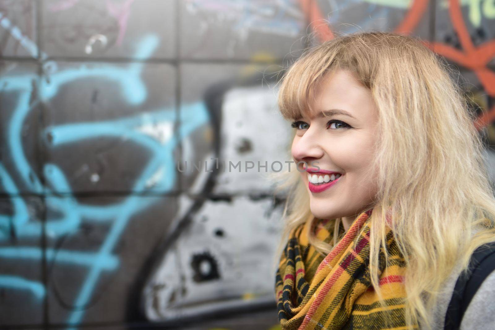 blonde urban teen girl against grafitti wall by Nickstock