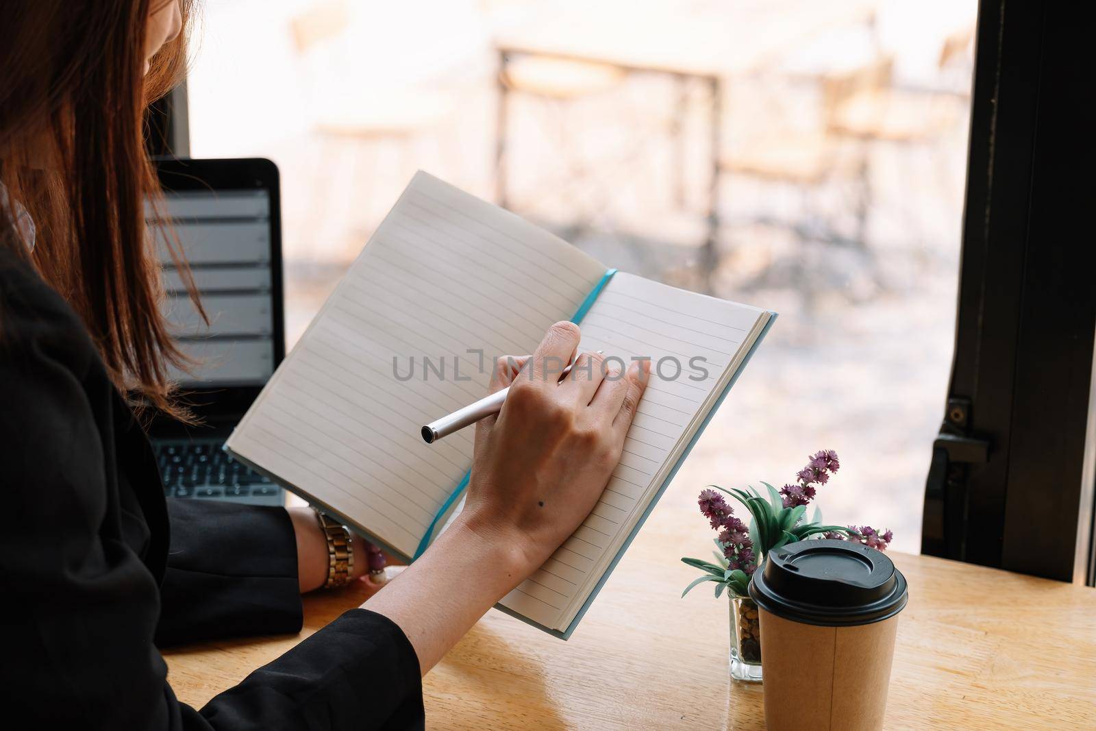 Close up of woman hold pen writing making notes in notebook studying at home, female handwrite in book, take educational course or training, seminar, education concept