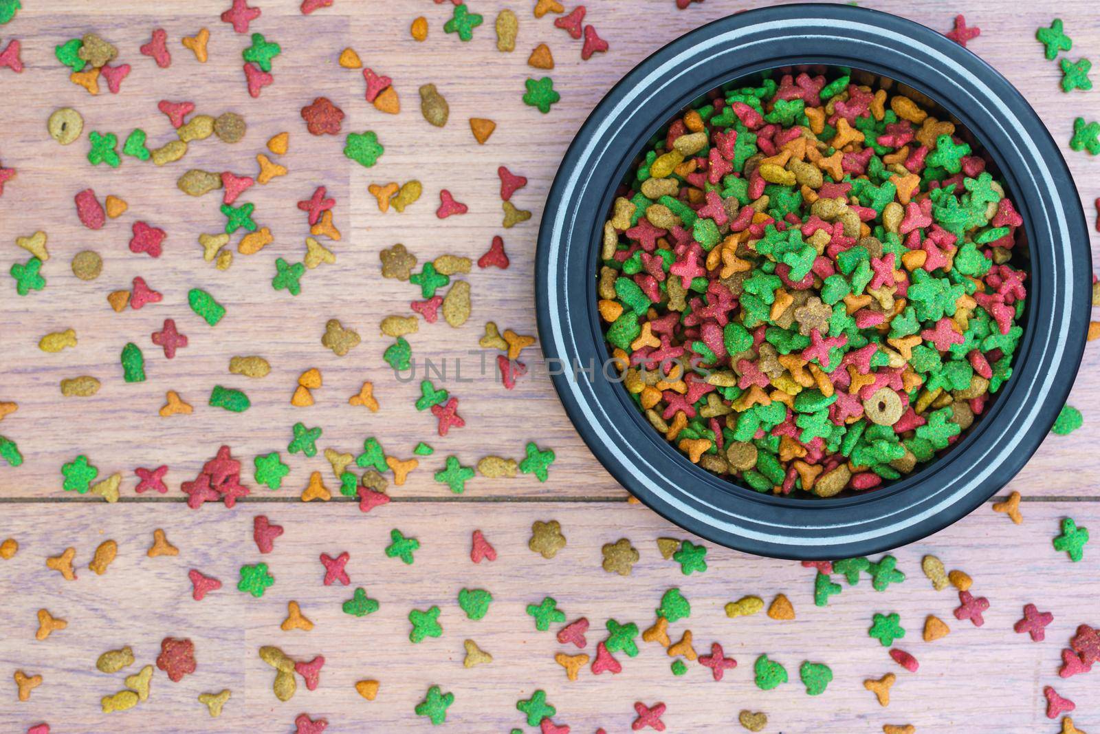 Cat food in bowl on wooden background by stoonn