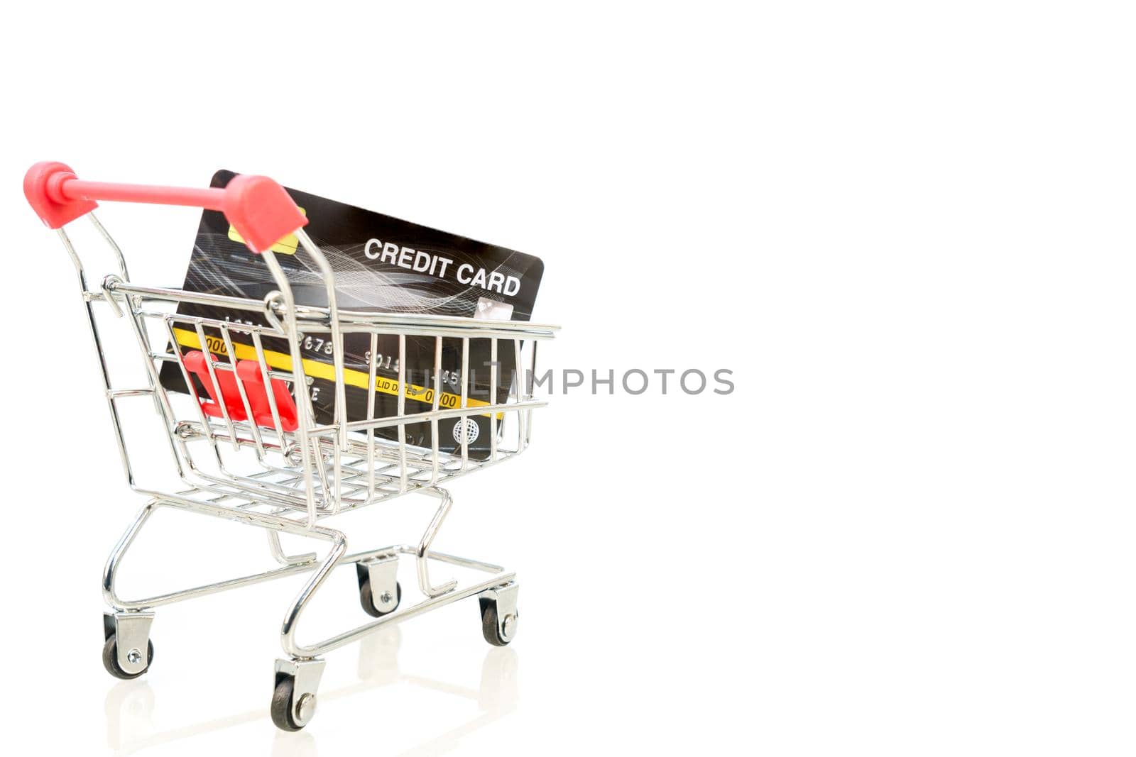 Credit card in shopping cart on white by stoonn