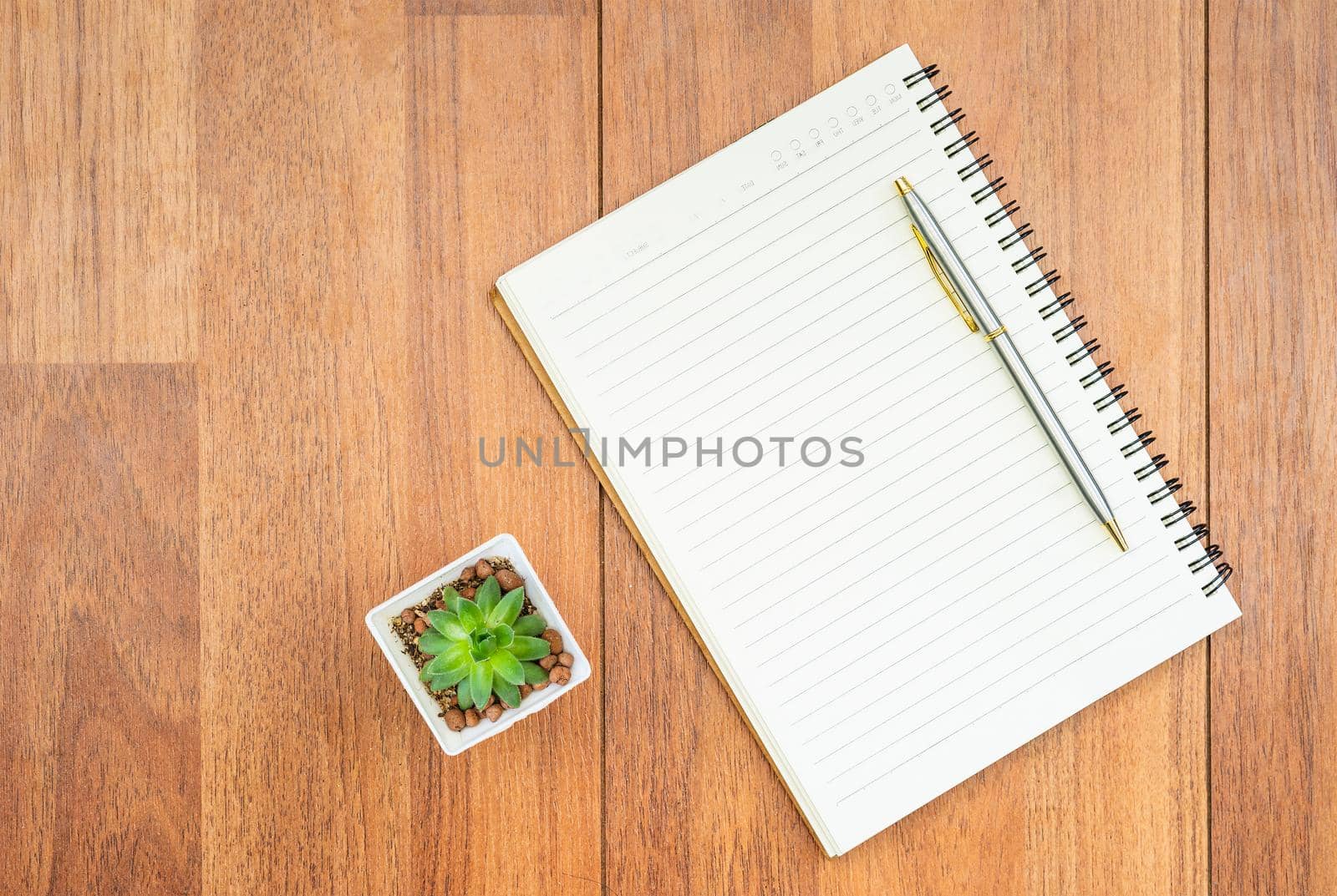 Top view pen and  notepad on wood deck with copyspace