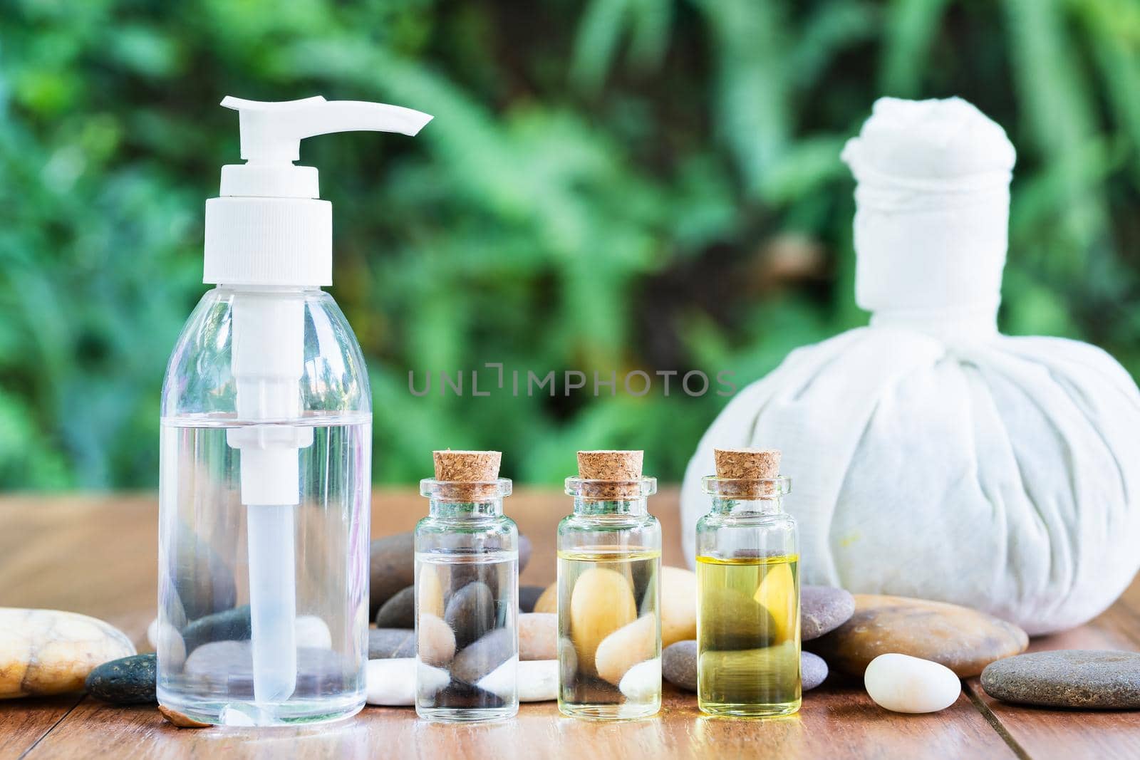 Thai Spa massage setting with bottle with essential oil and thai herbal compress balls