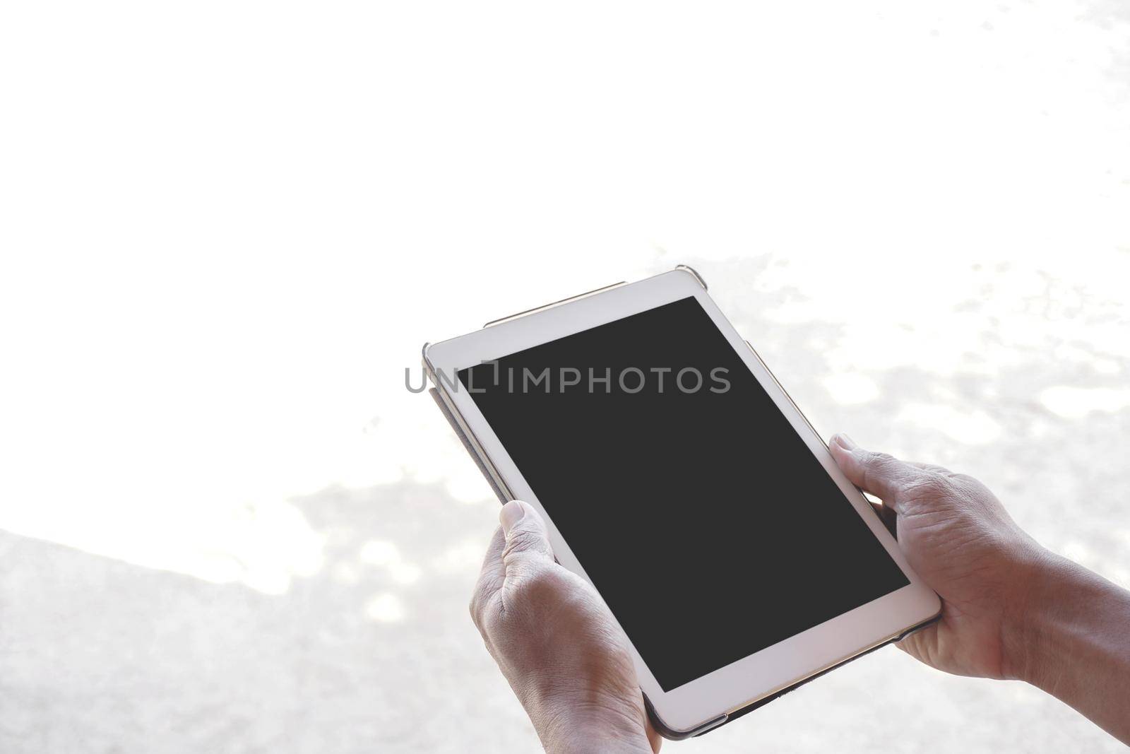 Close Up hands young man holding digital tablet blank black screen mockup                             