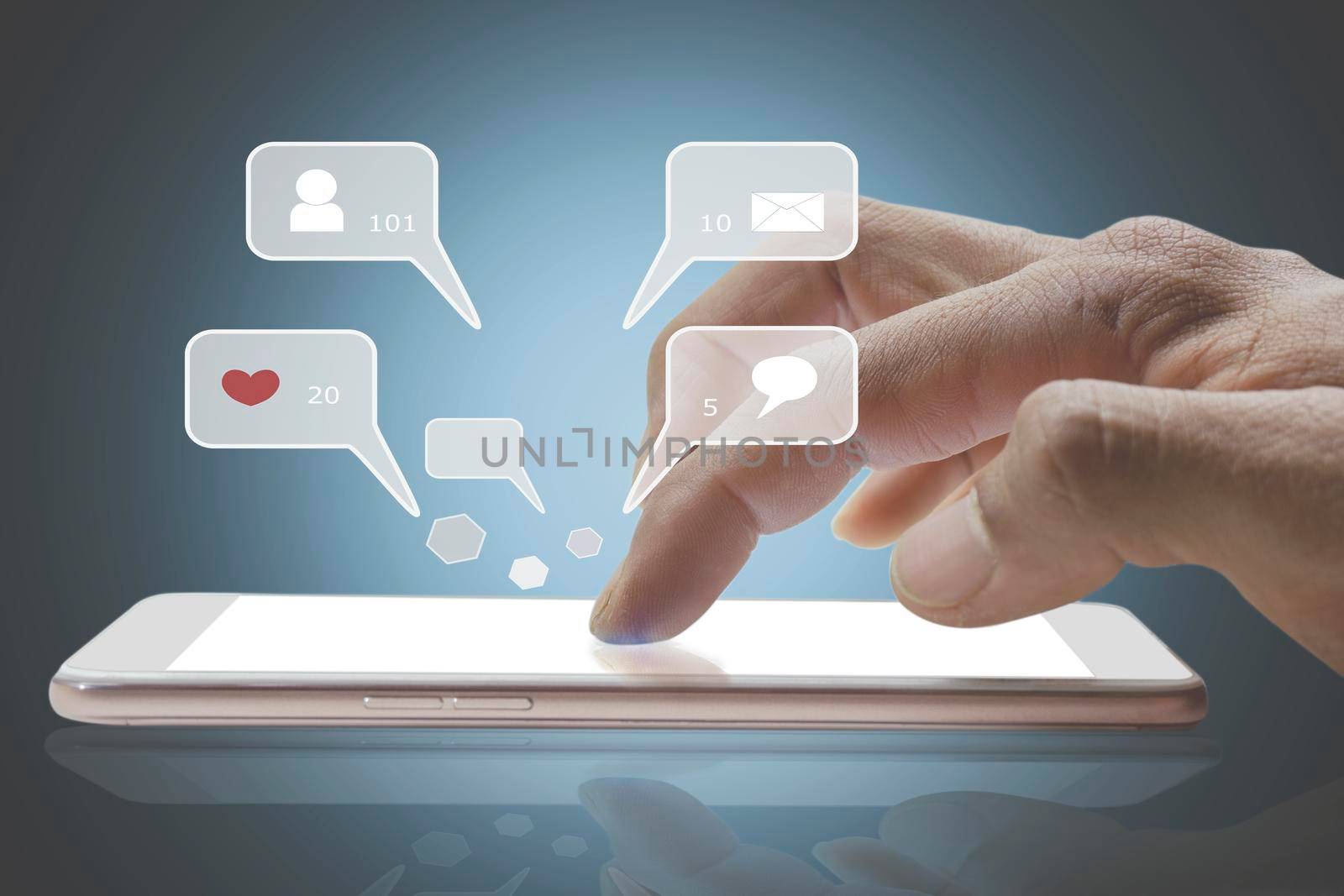 Closeup of person finger hand using a social media chat on a mobile phone with notification icons of like, message, comment, and star above smartphone screen. by yodsawai