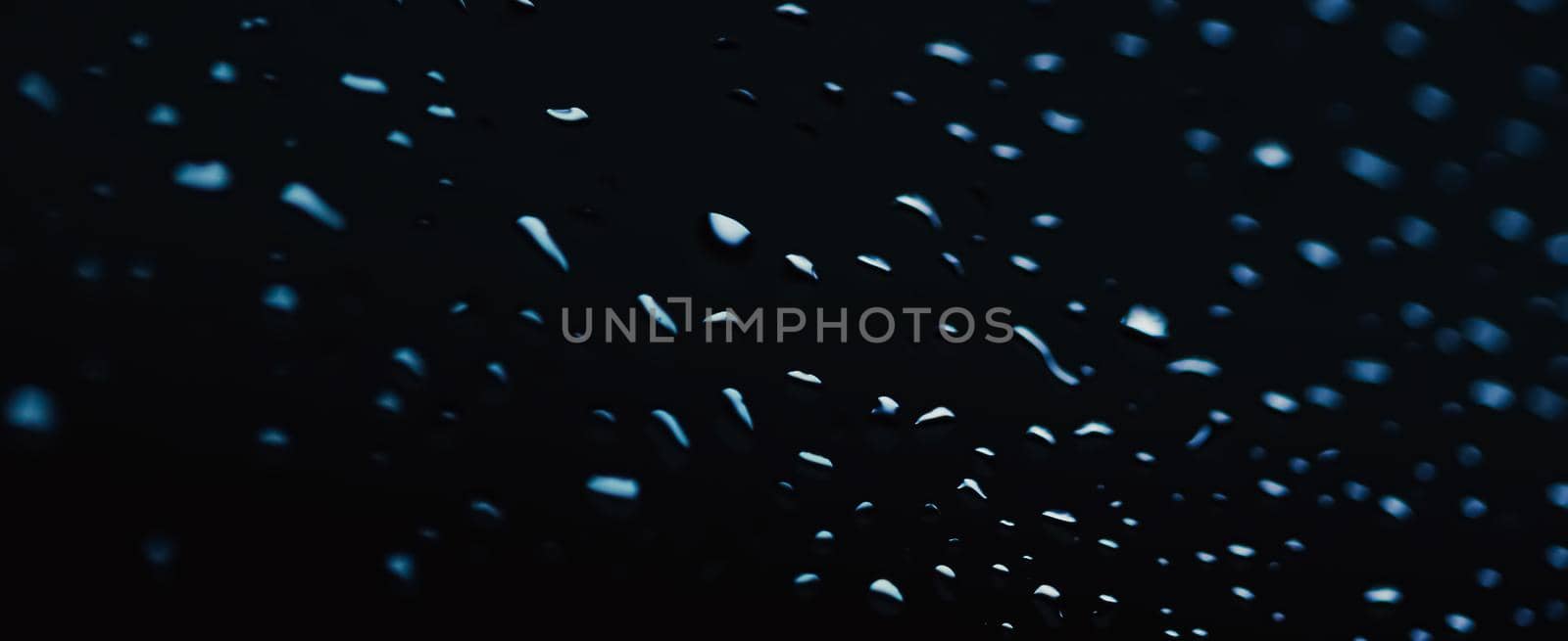 Liquid water drops on glass surface, abstract backdrop and science background by Anneleven