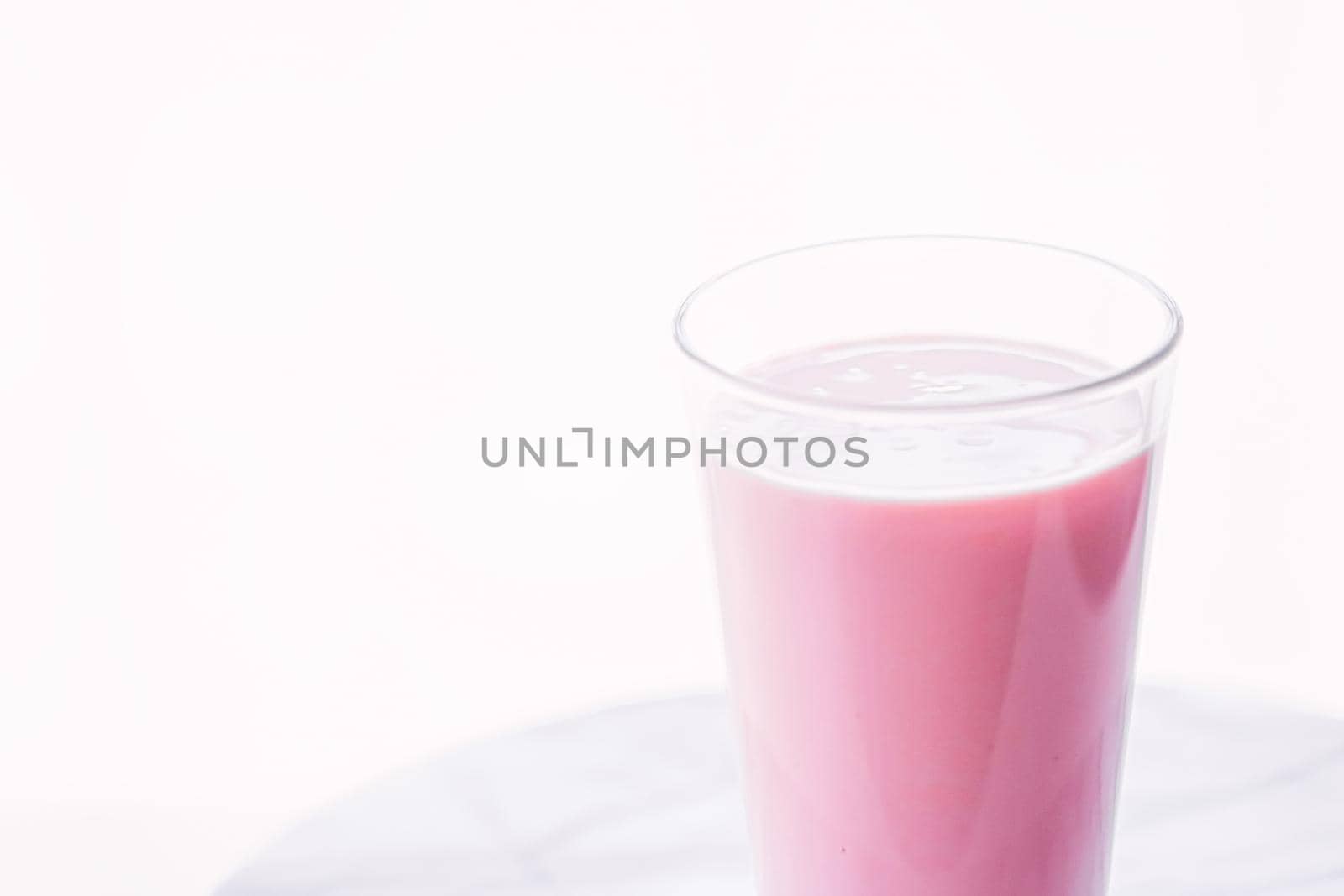 Strawberry milk on marble background as sweet drink, food service and meal delivery by Anneleven