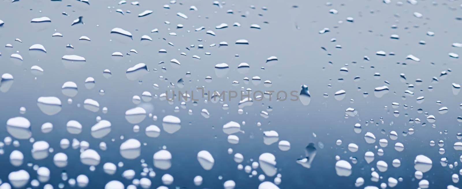 Liquid water drops on glass surface, abstract backdrop and science background by Anneleven