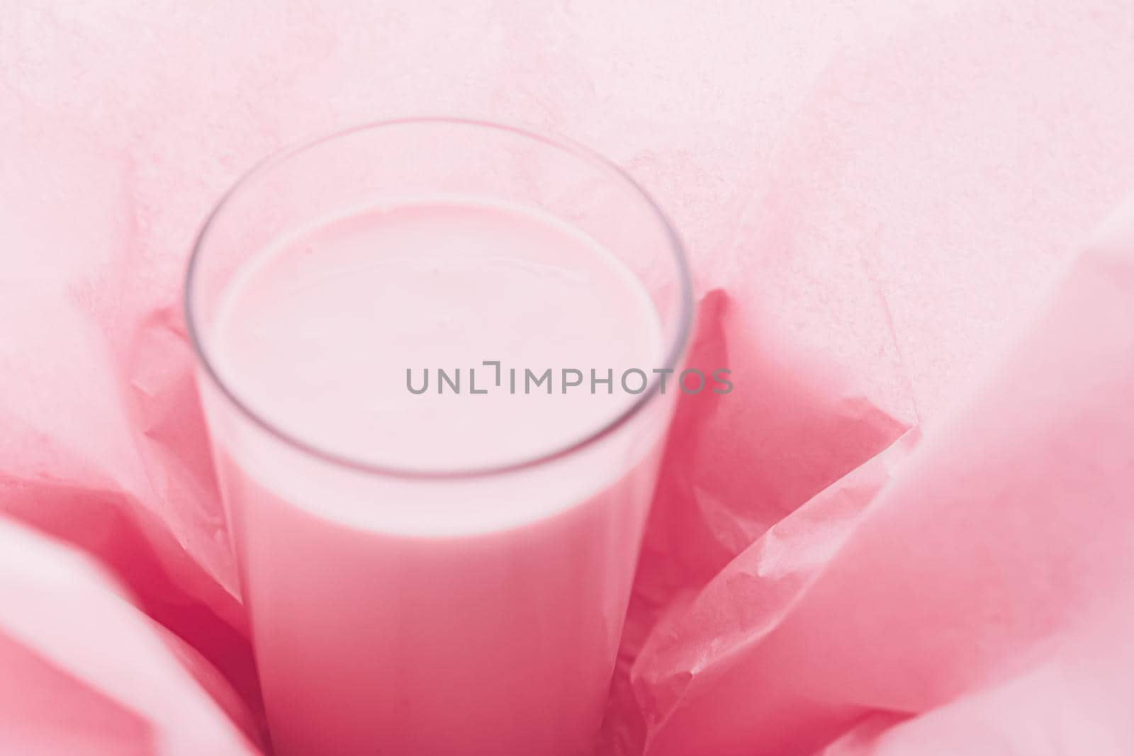 Strawberry milk inside pink paper packaging as sweet drink, food service flat lay and meal delivery by Anneleven