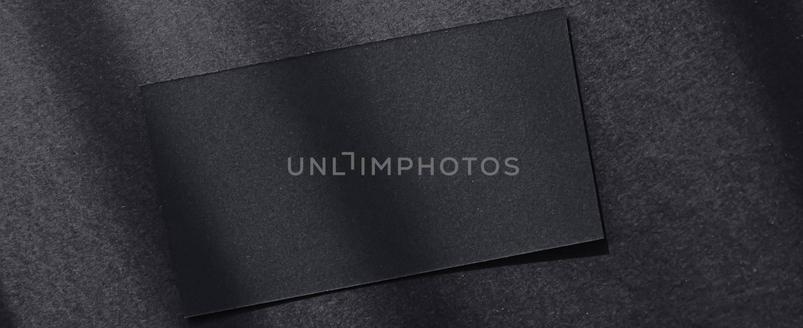 Black business card on dark flatlay background and sunlight shadows, luxury branding flat lay and brand identity design for mockups