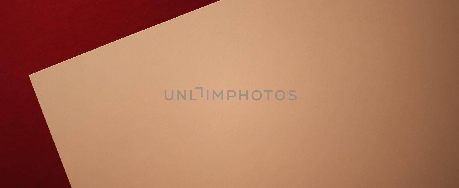 Beige A4 paper on dark red background as office stationery flatlay, luxury branding flat lay and brand identity design for mockups