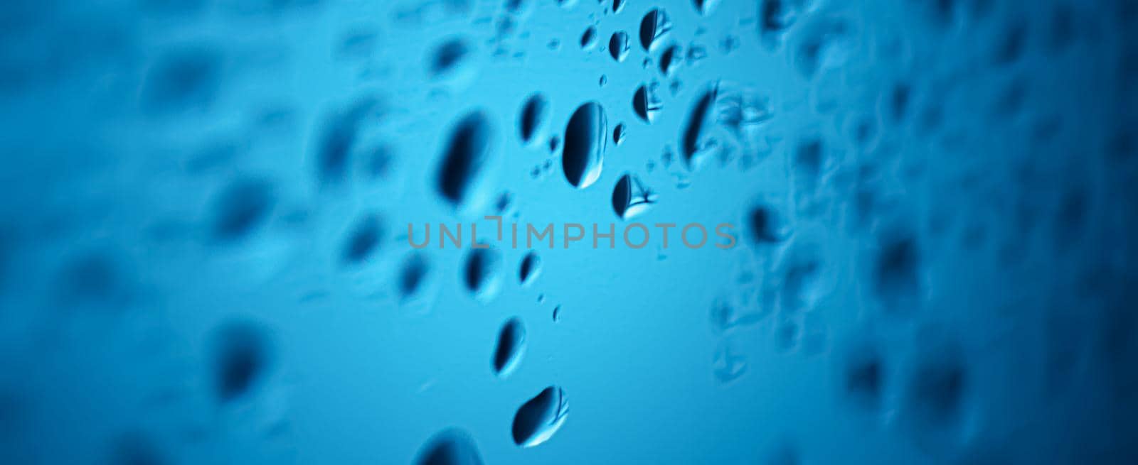 Liquid water drops on glass surface, abstract backdrop and science background by Anneleven