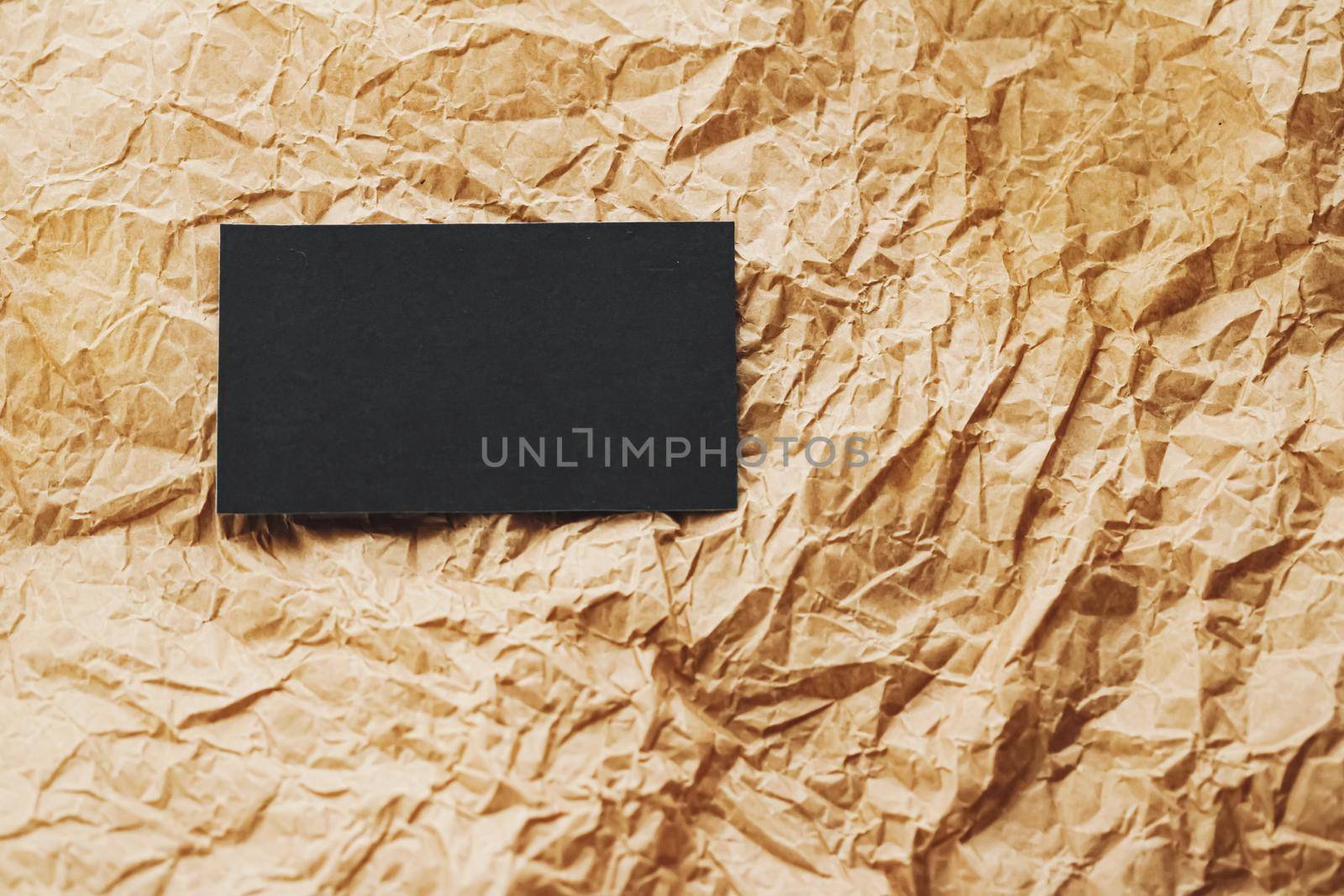 Black business card flatlay on brown parchment paper background, luxury branding flat lay and brand identity design for mockup by Anneleven