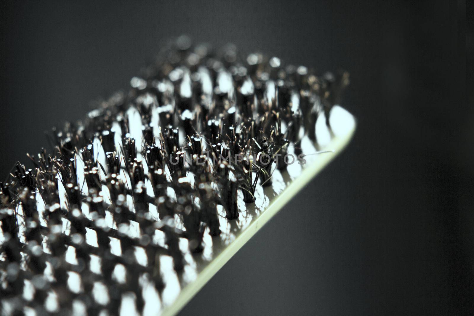 Hair brush with plastic bristles for straightening hair. No people