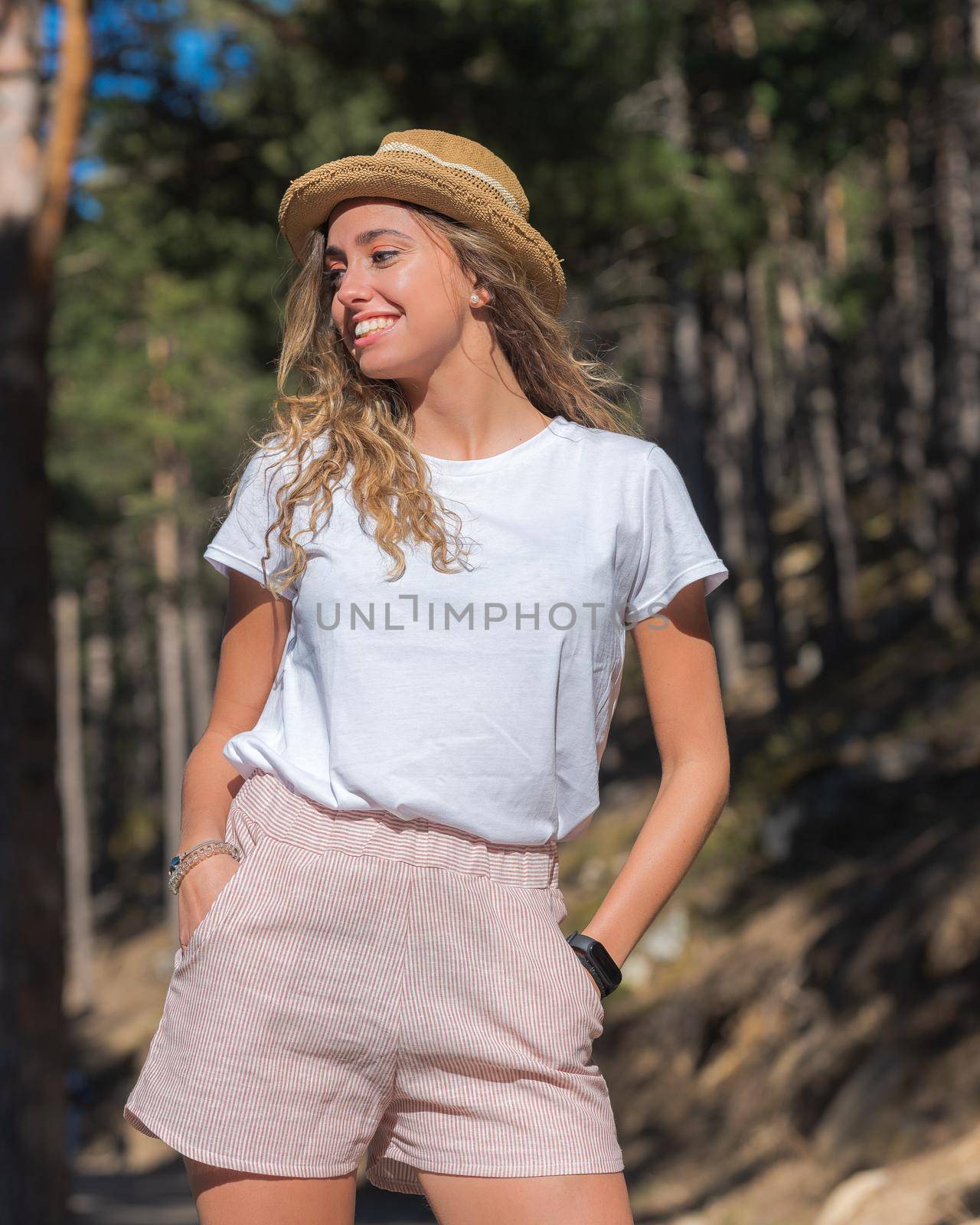 Pretty girl in the woods with hat in the woods in spring.