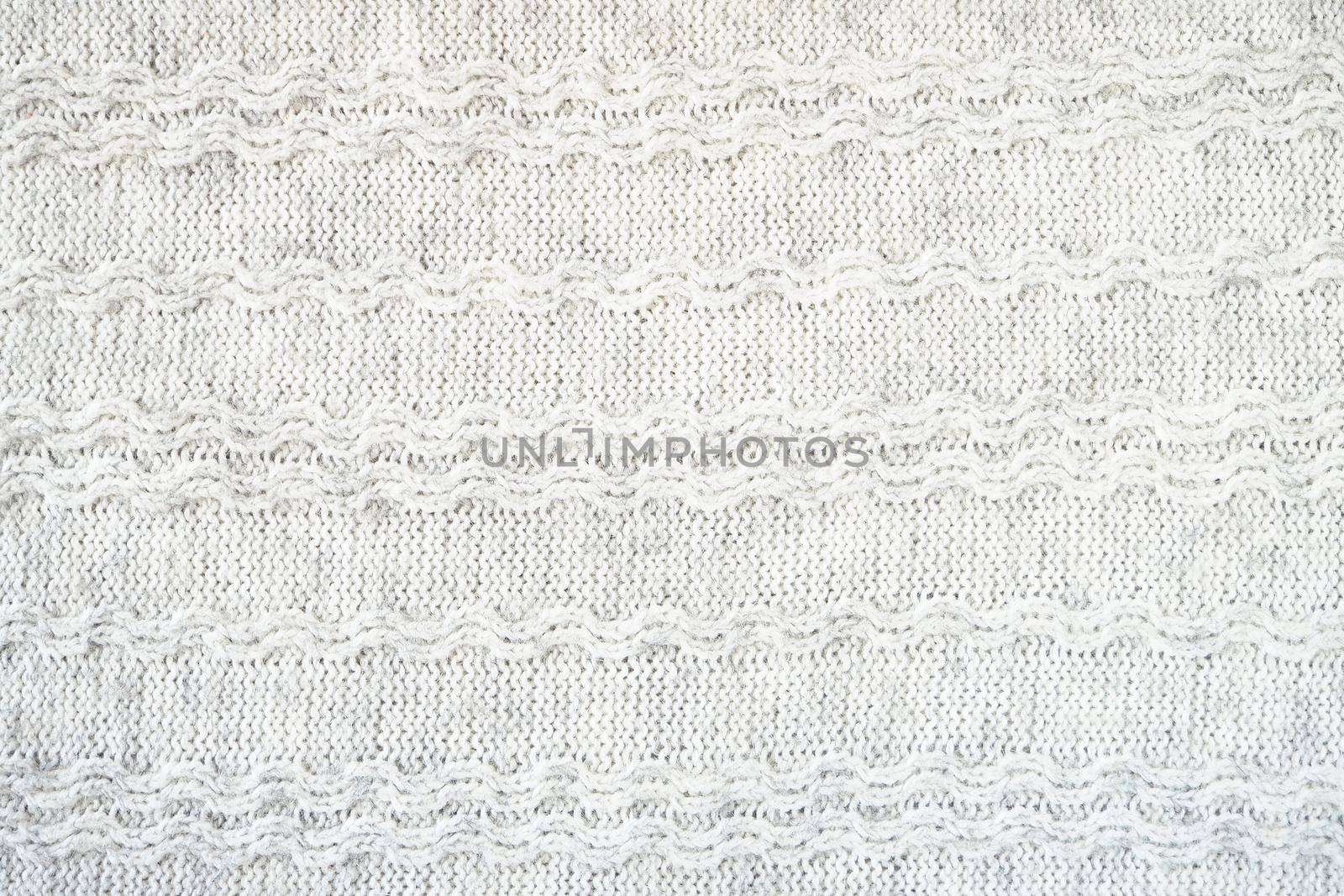 The texture of the woollen product. Grey background. High quality photo