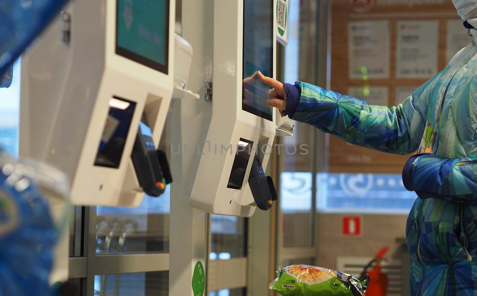 Shopping in the store. Pay with a bank card at the self-service terminal at the grocery store. by Olga26