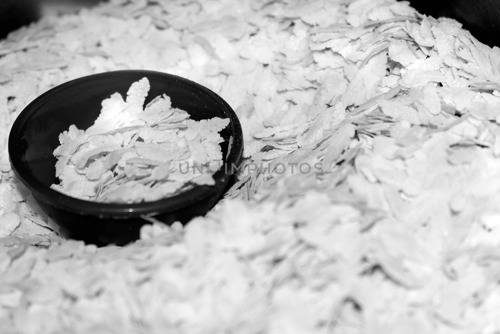 Black And White Pounding Paddy `POHA` or Flattened rice, Uncooked puffed rice flakes commonly use in India for breakfast