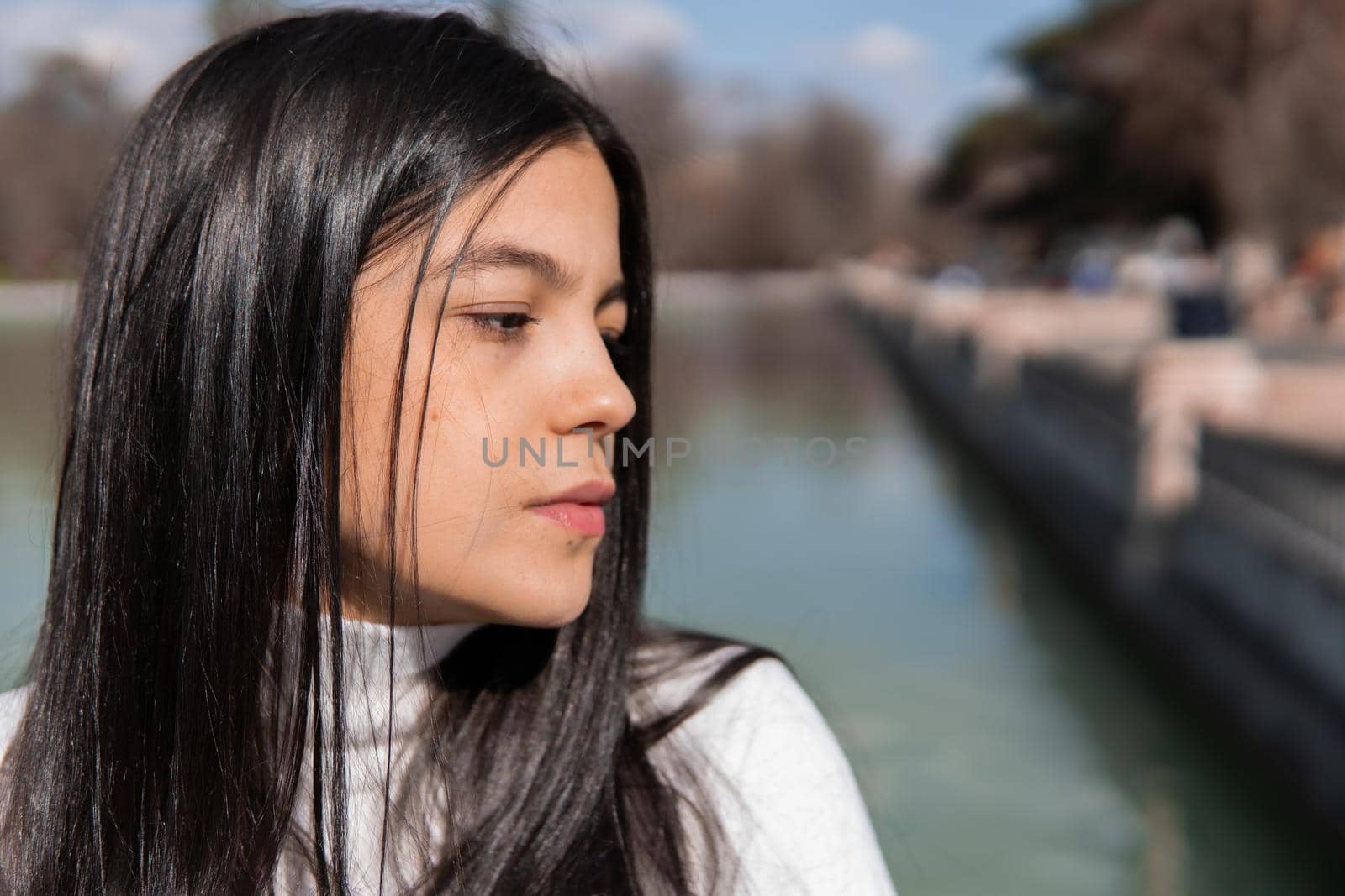 Portrait of young colombian girl with lake in the background by xavier_photo