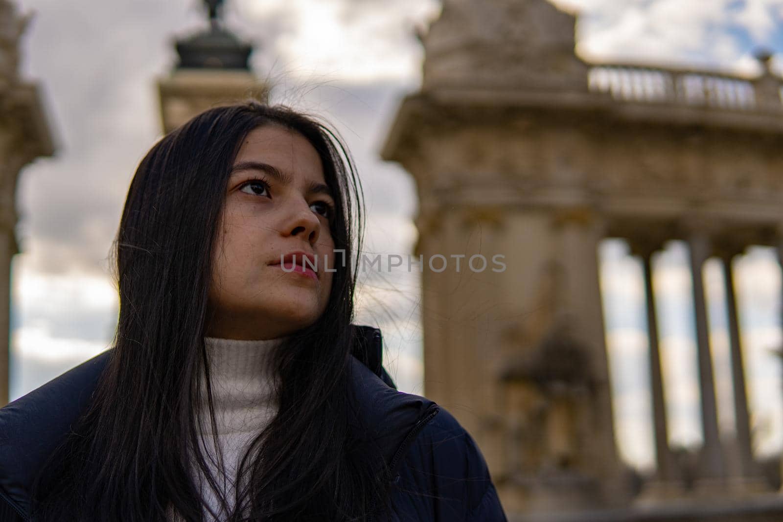 Portrait of young Colombian girl with antique architecture in the background