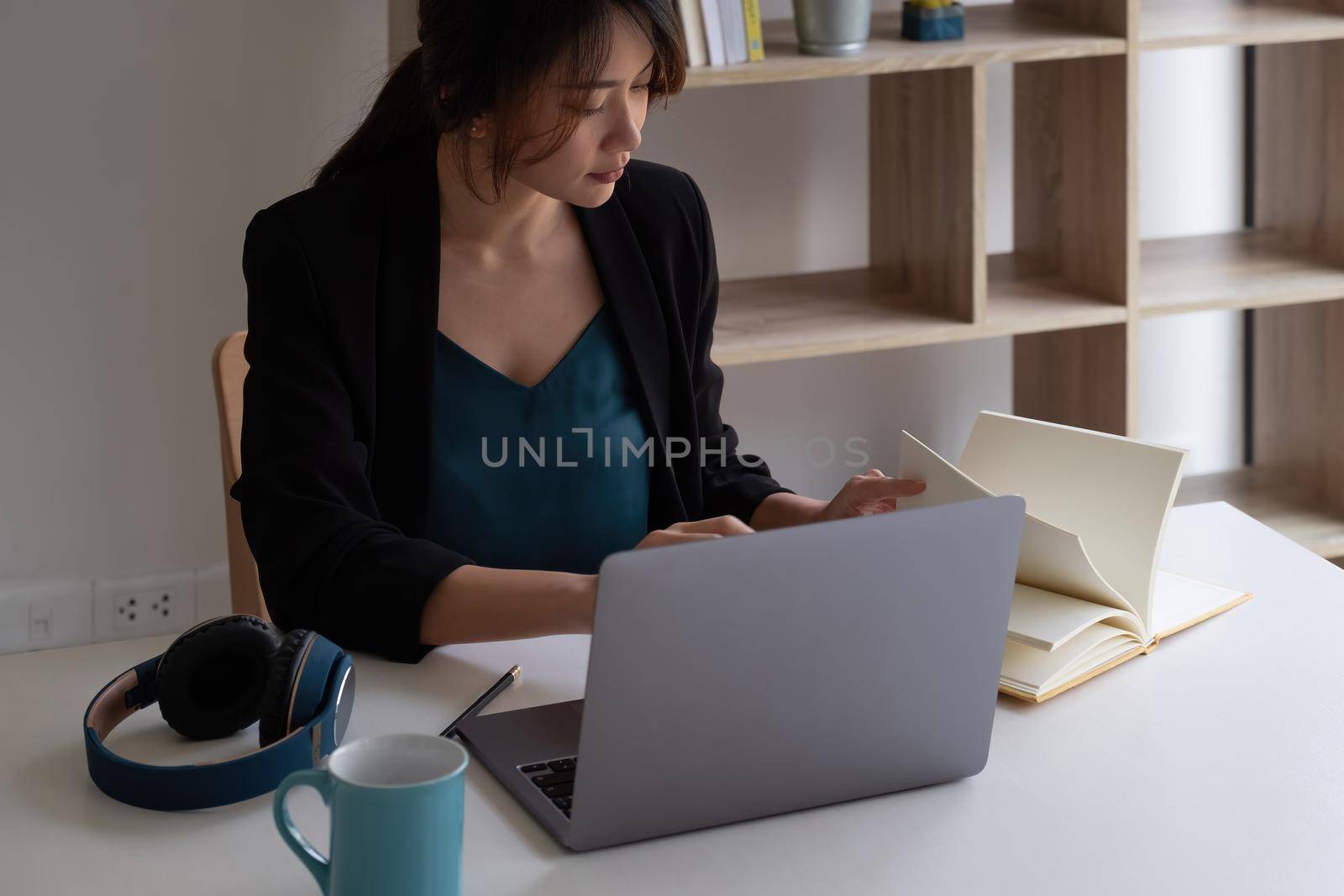 concentrated woman student busy studying using laptop make notes in notebook, focused man worker employee write watching webinar or online training course on computer, education concept