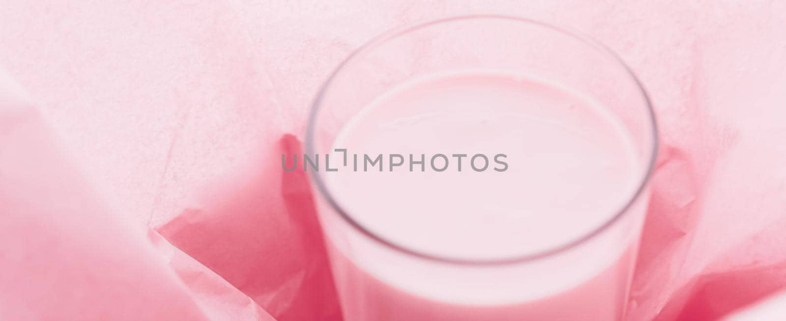 Strawberry milk inside pink paper packaging as sweet drink, food service flat lay and meal delivery by Anneleven