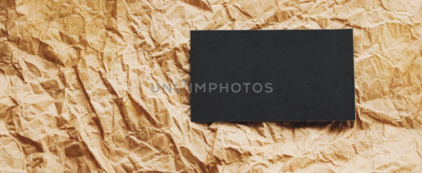 Black business card flatlay on brown parchment paper background, luxury branding flat lay and brand identity design for mockup by Anneleven