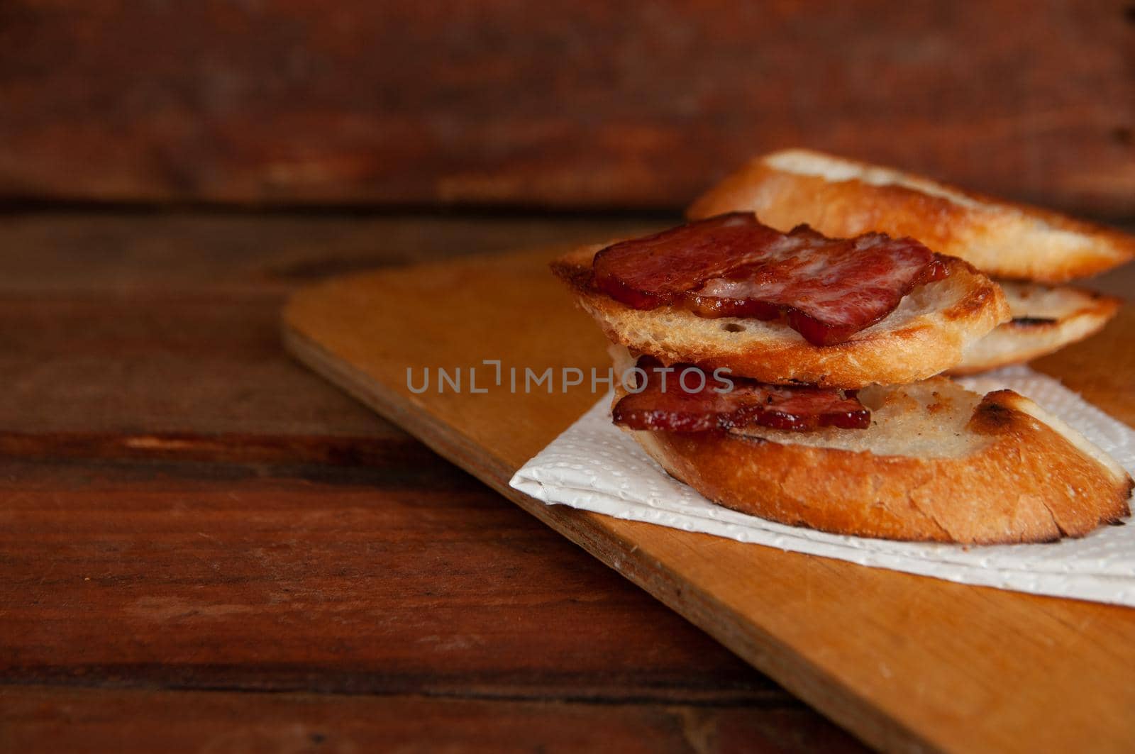 Using thick-sliced bacon to make a sandwich on whole-grain bread.