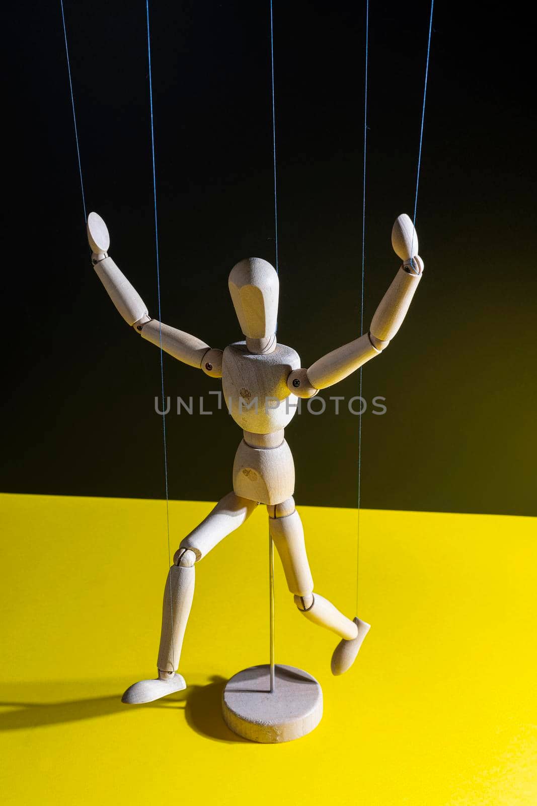 a wooden mannequin controlled with wires