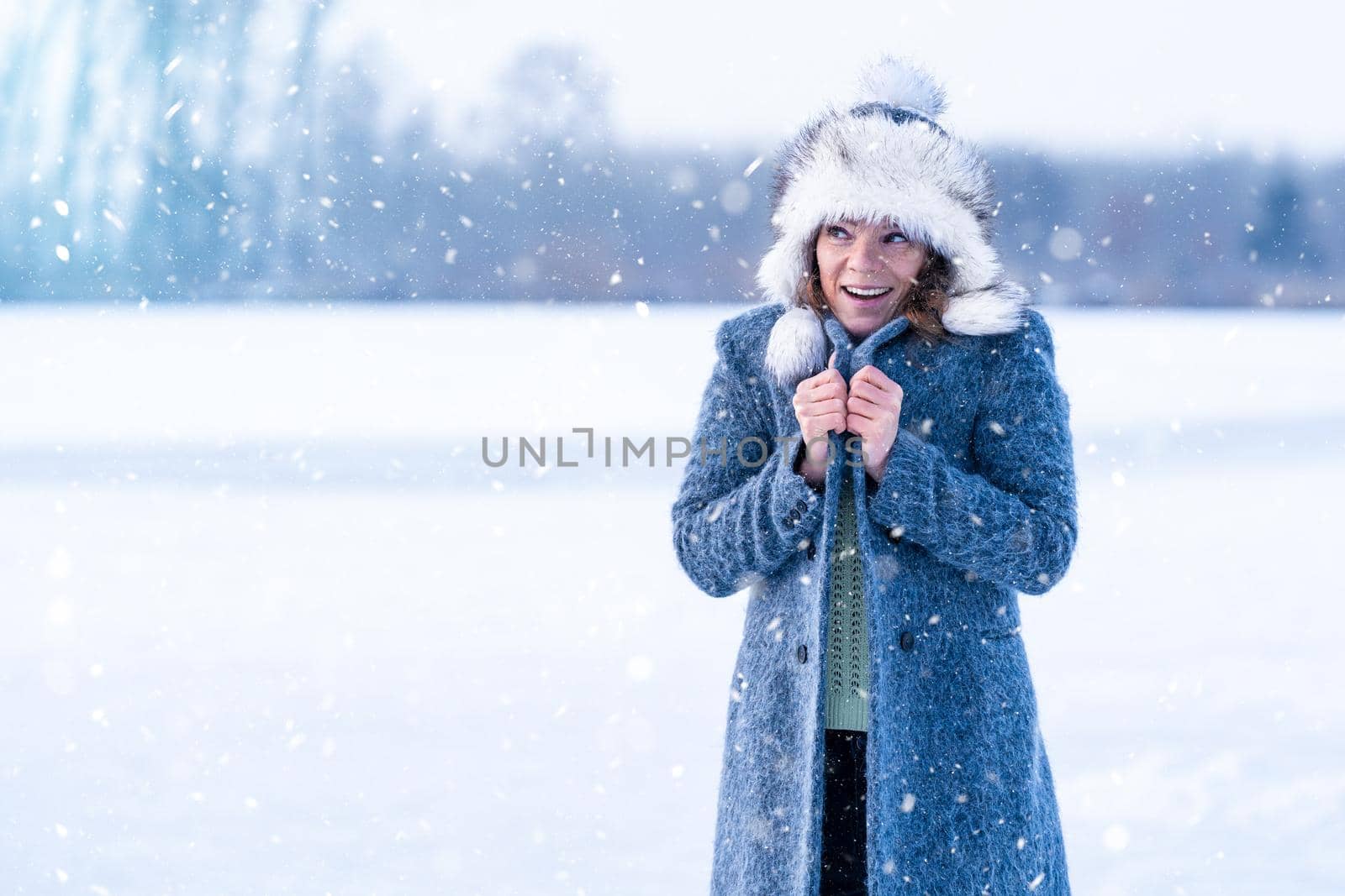 freezing woman on winter icy lake.