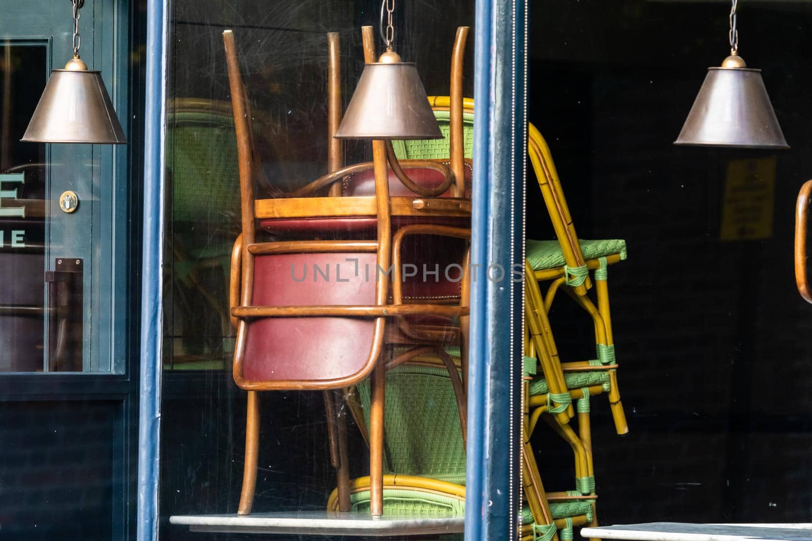 Chairs on the tables of a restaurant forced to close during lockdown to control COVID-19 pandemic, Cambridge, UK