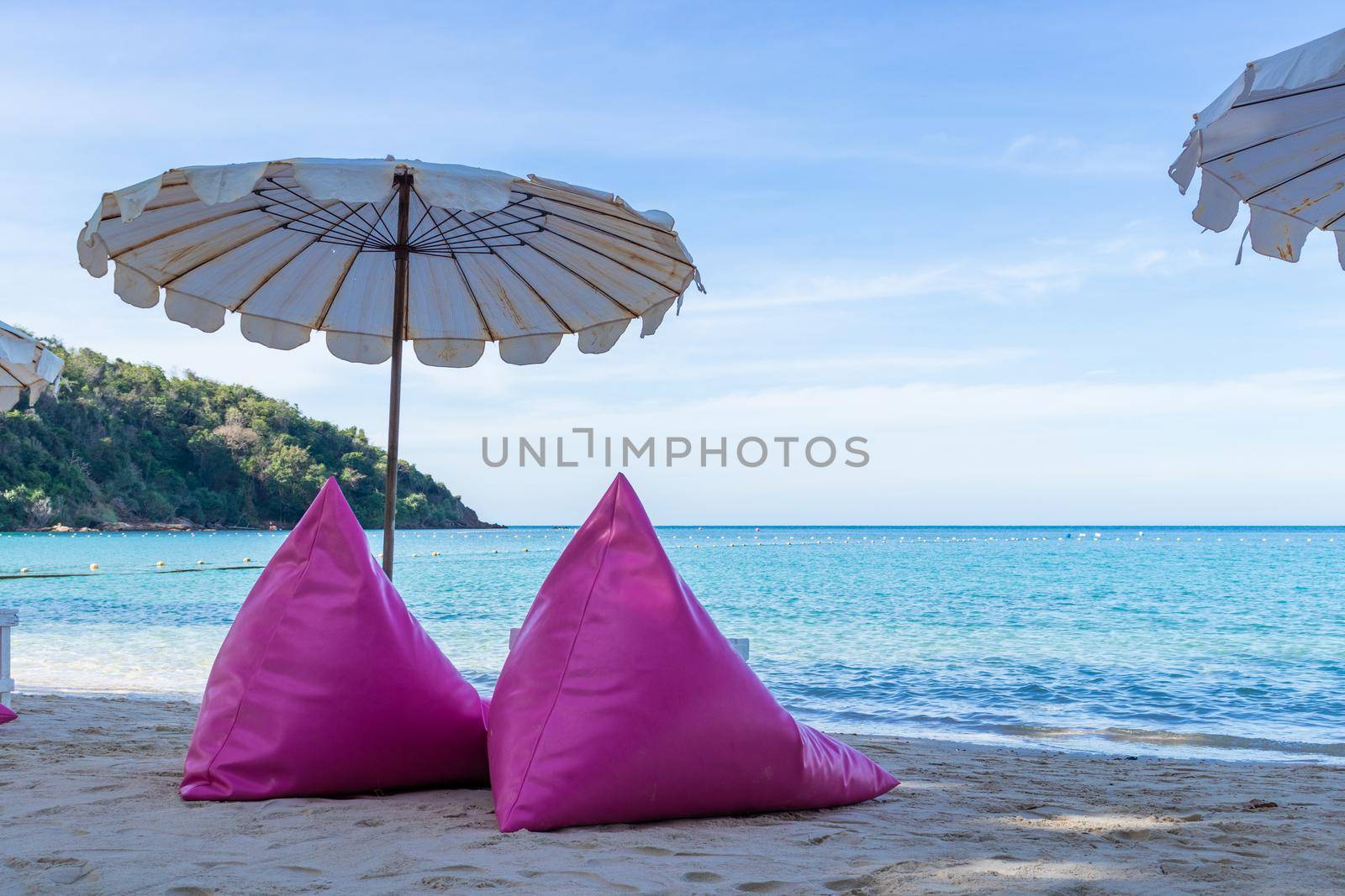 Pink inflatable sofa on the beach.