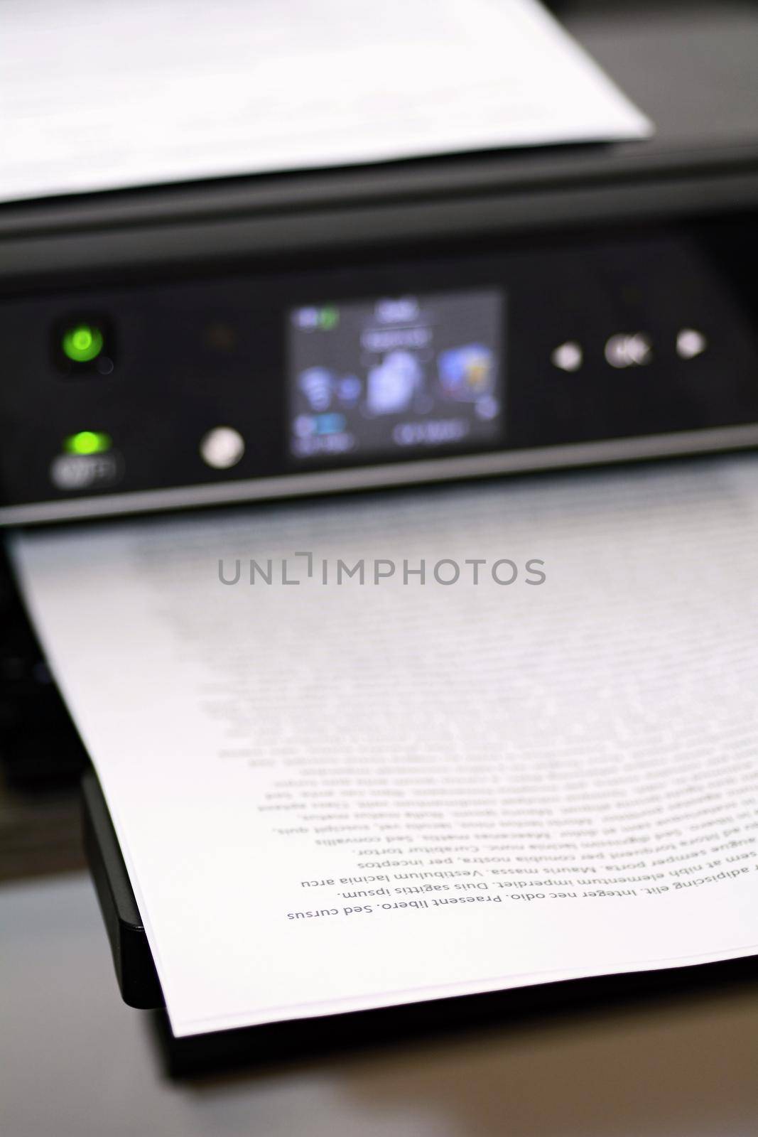Printed paper with lorem ipsum text in modern inkjet printer.