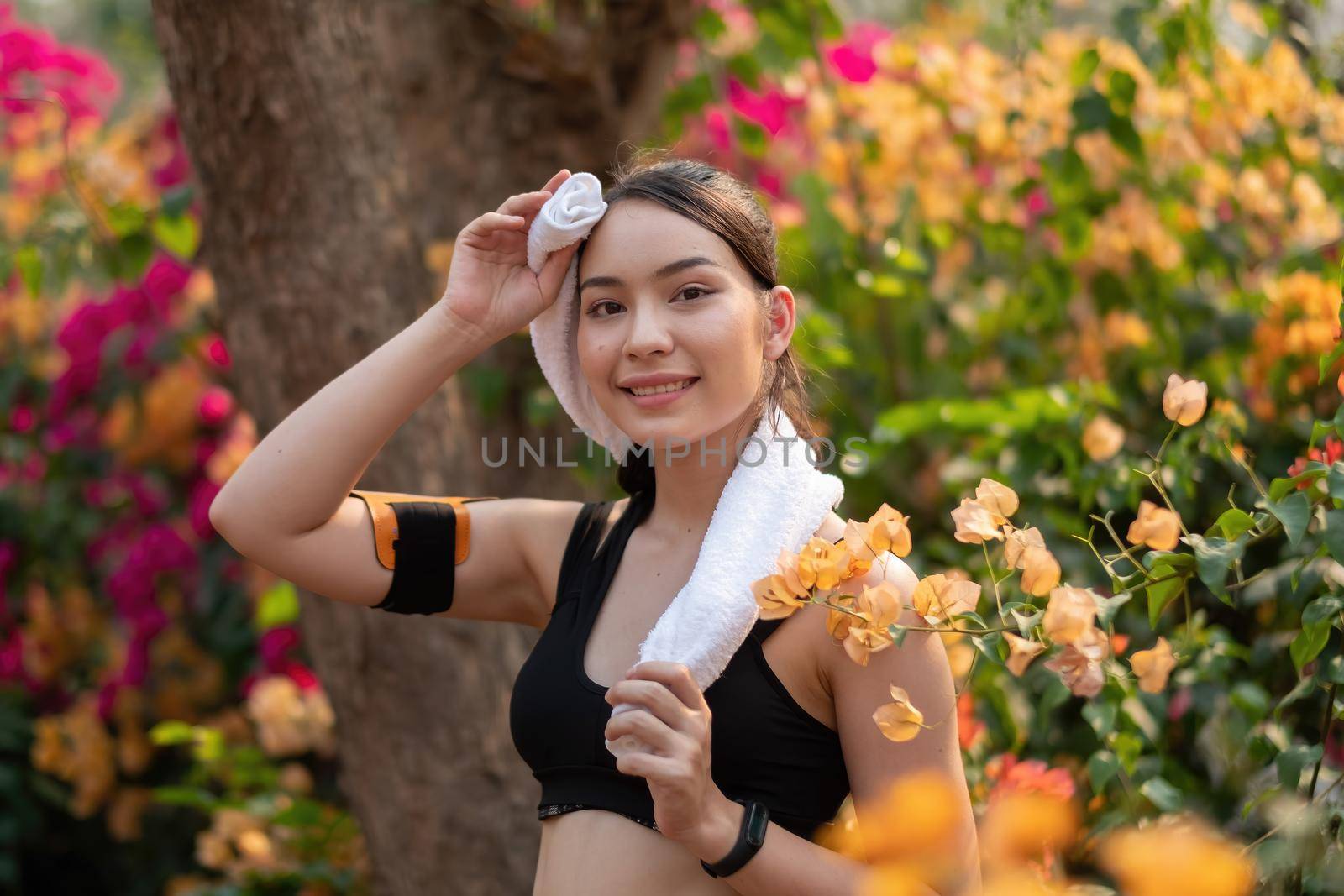 Portrait young athletic woman rest up after running in the park by nateemee